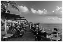 Waiting for sunset with drink in hand on Mallory Square. Key West, Florida, USA (black and white)