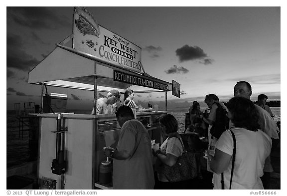 People buying food at stand on Mallory Square. Key West, Florida, USA (black and white)