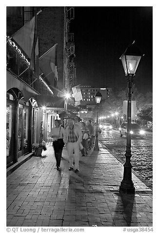 People on sidewalk of River Street by night. Savannah, Georgia, USA (black and white)