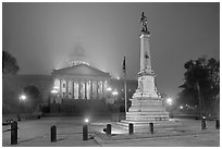 Monument to Confederate soldiers and state capitol at night. Columbia, South Carolina, USA ( black and white)