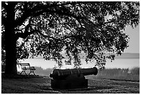 Cannon, and bench overlooking Beaufort Bay at sunrise. Beaufort, South Carolina, USA (black and white)