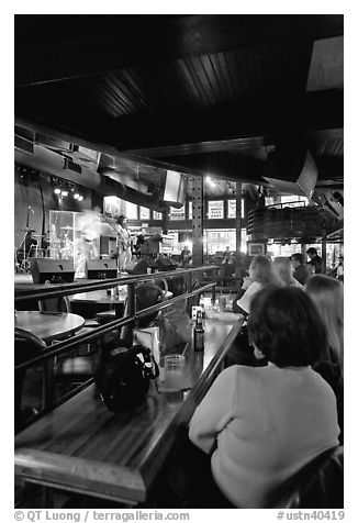 Patrons listen to musical performance in Beale Street bar. Memphis, Tennessee, USA (black and white)