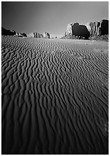 Ripples on sand dunes and mesas, late afternoon. Monument Valley Tribal Park, Navajo Nation, Arizona and Utah, USA ( black and white)
