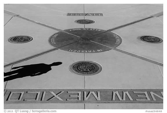 Shadow and state seals. Four Corners Monument, Arizona, USA (black and white)