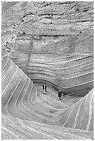 Hikers at the bottom of the Wave. Coyote Buttes, Vermilion cliffs National Monument, Arizona, USA ( black and white)