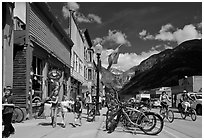 Children walking on main street past mountain bikes. Telluride, Colorado, USA (black and white)