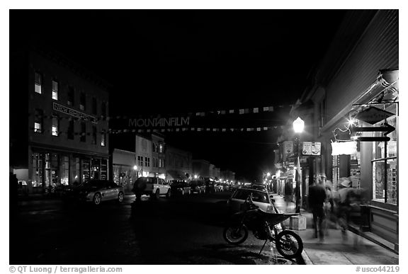 People walking by store on Colorado Street by night. Telluride, Colorado, USA (black and white)
