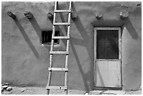 Ladder on adobe facade. Taos, New Mexico, USA (black and white)