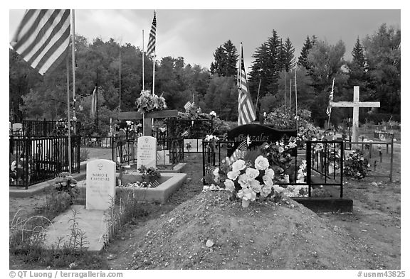 Headstones, tombs and american flags. Taos, New Mexico, USA (black and white)