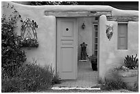 Adobe style walls, blue doors and windows, and courtyard. Taos, New Mexico, USA ( black and white)
