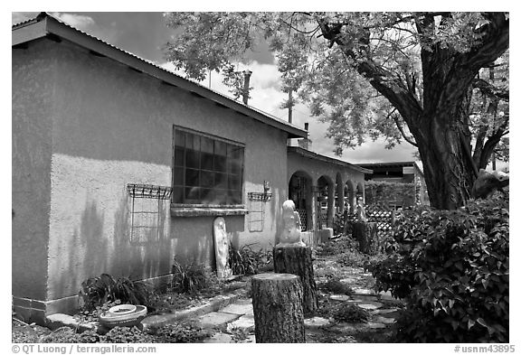 Gallery with sculptures in front yard, Truchas. New Mexico, USA (black and white)