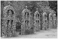 Brick and stone crosses by the river, Sanctuario de Chimayo. New Mexico, USA (black and white)