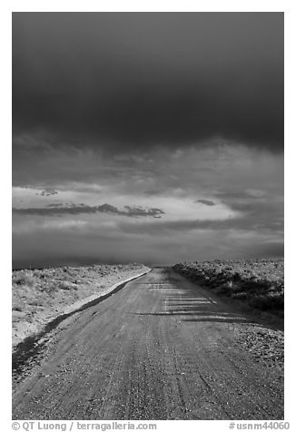 Dirt road under storm clouds. New Mexico, USA (black and white)