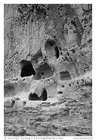 Natureal cavities and architectural carvings in tuff wall. Bandelier National Monument, New Mexico, USA (black and white)