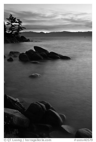 Sunset over lake with boulders, Sand Harbor, East Shore, Lake Tahoe, Nevada. USA (black and white)