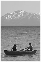Man and woman in canoe with snowy mountains in the background, Lake Tahoe, Nevada. USA ( black and white)