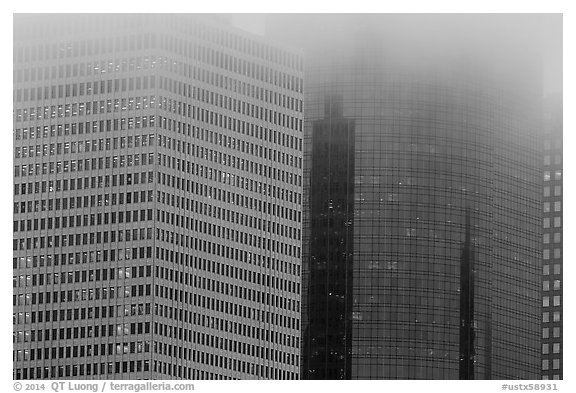 Top of high-rise buildings capped by fog. Houston, Texas, USA (black and white)