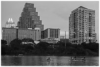 Water pedaling in front of skyline at dusk. Austin, Texas, USA ( black and white)