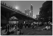 People gathered for dusk bat flight at Congress Bridge. Austin, Texas, USA ( black and white)