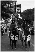 Women riding horses on sidewalk, Stockyards. Fort Worth, Texas, USA ( black and white)