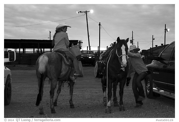 Women preparing to ride horses. Fort Worth, Texas, USA (black and white)