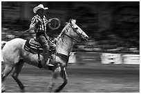 Rodeo contestant riding horse. Fort Worth, Texas, USA ( black and white)