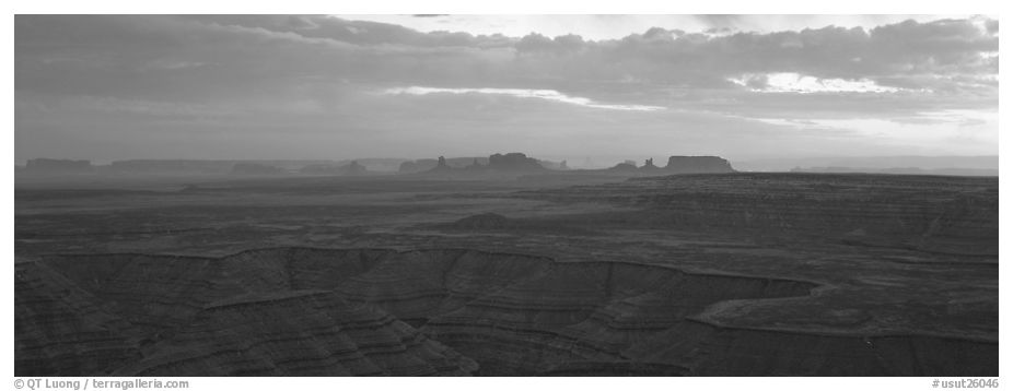 Sunset over canyon and distant mesas. Monument Valley Tribal Park, Navajo Nation, Arizona and Utah, USA (black and white)