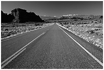 Road, sandstone cliffs, snowy mountains. Utah, USA (black and white)