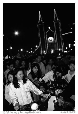 Women on motorbike in front of St Joseph Cathedral on Christmas eve. Ho Chi Minh City, Vietnam (black and white)