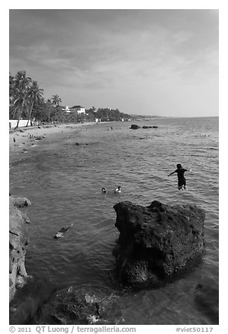 Child jumping in water, Duong Dong. Phu Quoc Island, Vietnam (black and white)