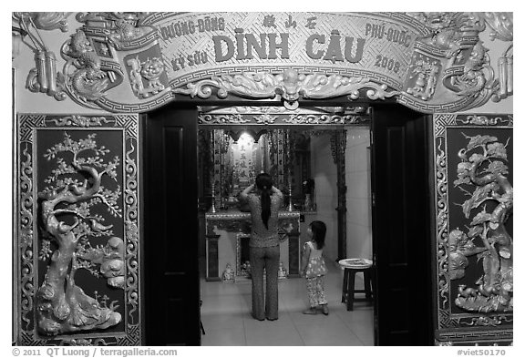 Woman with girl worshipping at Dinh Cau temple, Duong Dong. Phu Quoc Island, Vietnam (black and white)