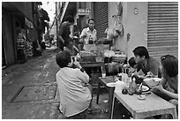 Breakfast at food stall in alley. Ho Chi Minh City, Vietnam (black and white)