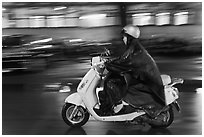 Scooter rider on rainy night. Ho Chi Minh City, Vietnam (black and white)