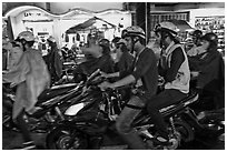 Street crowded with motorcycles on rainy night. Ho Chi Minh City, Vietnam (black and white)