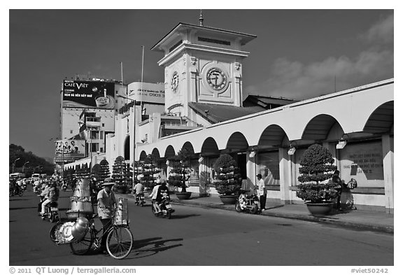 Food vendor riding outside Ben Thanh Market. Ho Chi Minh City, Vietnam (black and white)