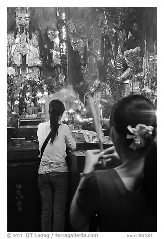Women holding incense sticks, Phuoc Hai Tu pagoda, district 3. Ho Chi Minh City, Vietnam