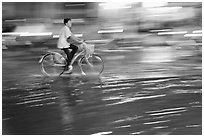 Night Bicyclist, water, and motion light streaks. Ho Chi Minh City, Vietnam (black and white)