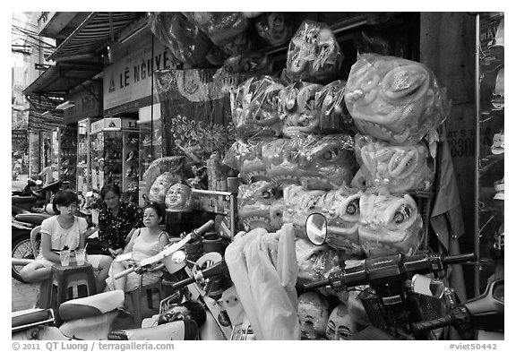 Shop selling dragon heads used for traditional dancing. Cholon, Ho Chi Minh City, Vietnam (black and white)