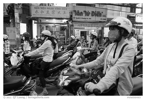 Commuters on motorcyles in stopped traffic. Ho Chi Minh City, Vietnam (black and white)