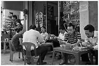 Men eating breakfast on the street. Ho Chi Minh City, Vietnam ( black and white)
