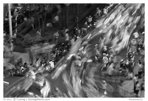 Flow of motorcycle traffic at night from above. Ho Chi Minh City, Vietnam (black and white)