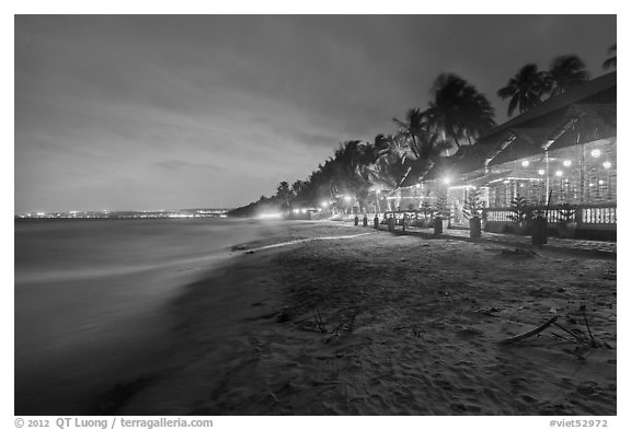 Beach bordered by resorts at night. Mui Ne, Vietnam (black and white)