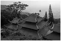 Temple rooftop overlooking plains in mist. Ta Cu Mountain, Vietnam ( black and white)