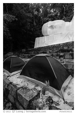Child and tents set up below head of Buddha statue. Ta Cu Mountain, Vietnam (black and white)