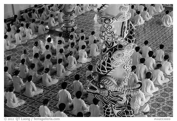 Column and worshippers, Cao Dai Holy See temple. Tay Ninh, Vietnam