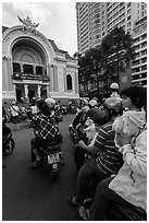 Family on motorbike watching performance at opera house. Ho Chi Minh City, Vietnam ( black and white)