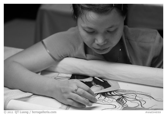 Woman working on a silk embroidery piece. Hoi An, Vietnam (black and white)