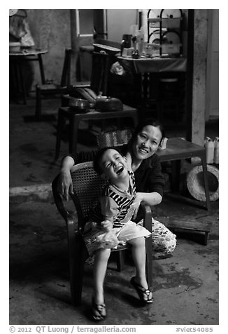 Boy and woman in kitchen. Hoi An, Vietnam (black and white)