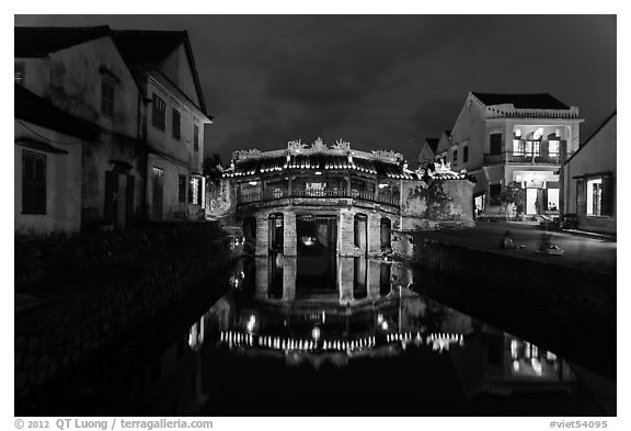 Japanese covered bridge reflected in canal at night. Hoi An, Vietnam (black and white)