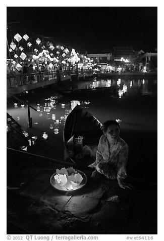 Woman selling candle lanterns by the bridge. Hoi An, Vietnam (black and white)